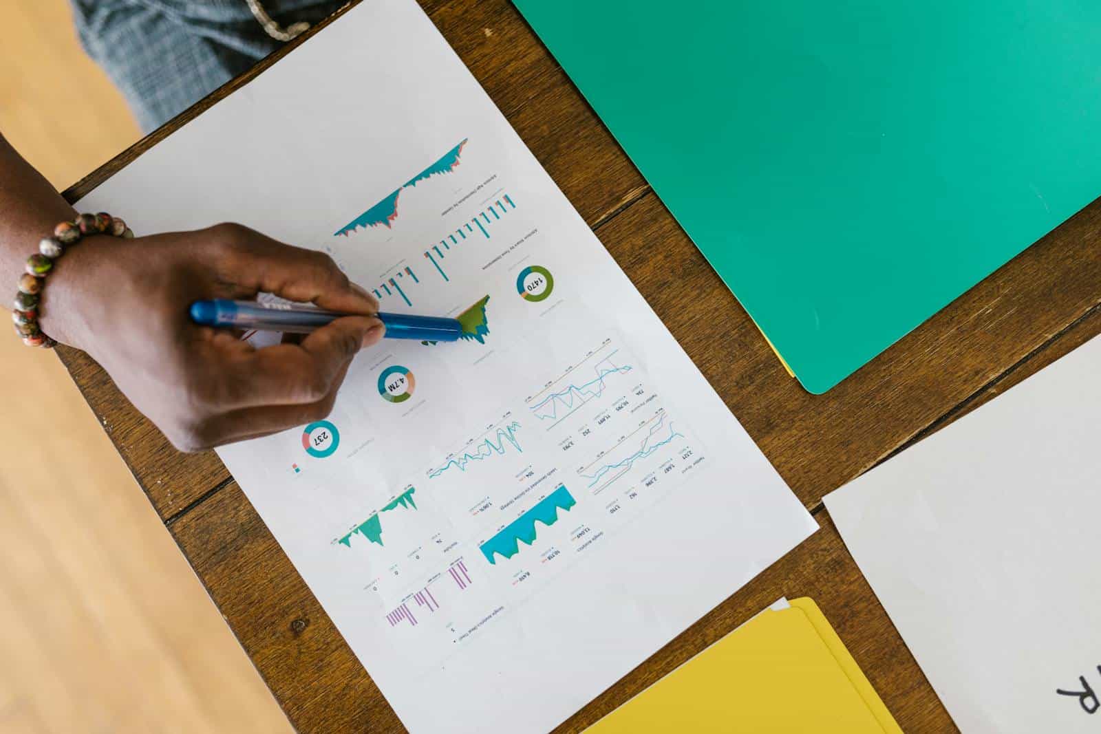 Overhead view of a person analyzing business charts and graphs on paper. Social Media Marketing