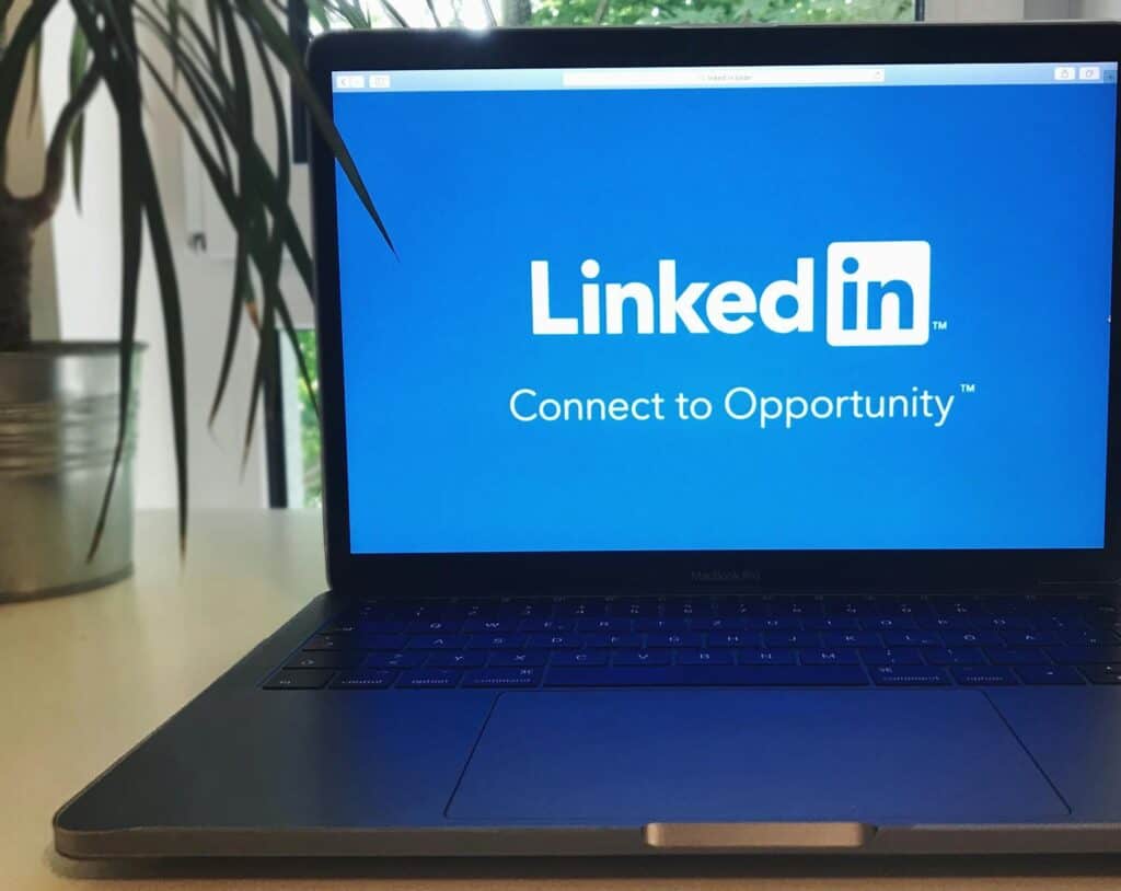 LinkedIn Marketing, A laptop screen displaying the LinkedIn logo with the text 'Connect to Opportunity'.