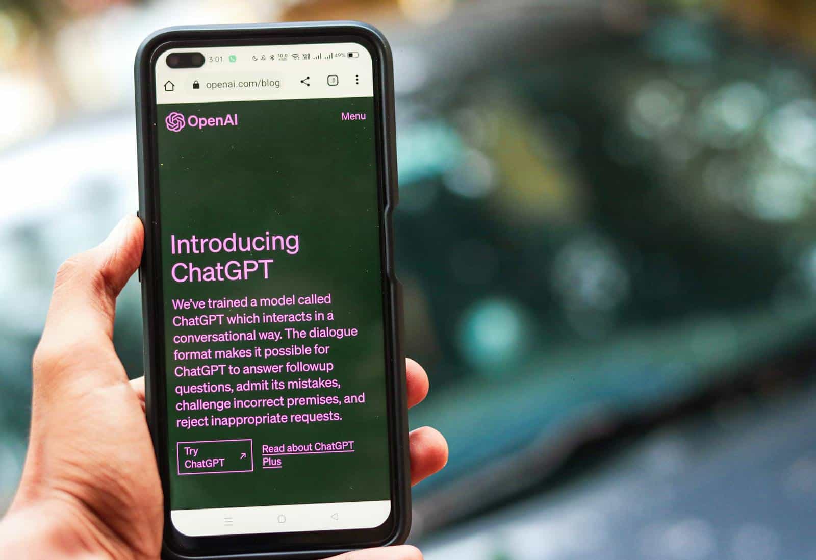 Close-up of a smartphone showing ChatGPT details on the OpenAI website, held by a person. Chatbot, Customer Service