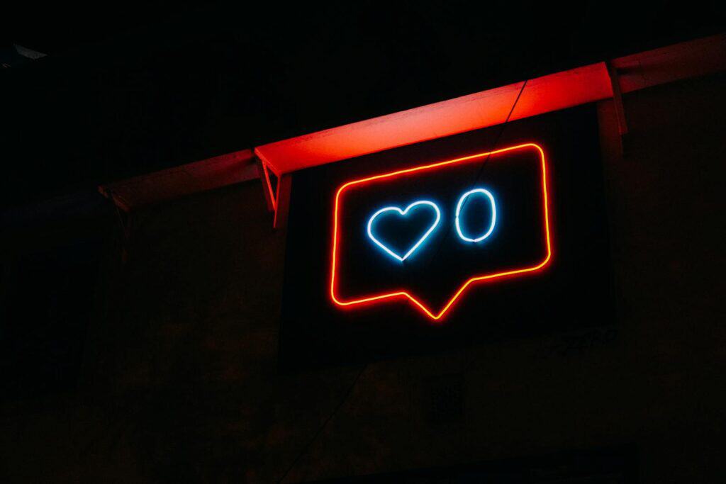 Instagram, Marketing, Algorithm, Bright neon heart icon with zero likes, symbolizing social media engagement.