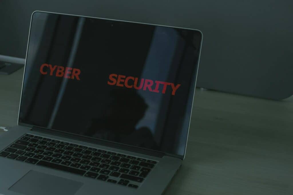 encryption, online security, data protection, Close-up of a laptop displaying cybersecurity text, emphasizing digital security themes.