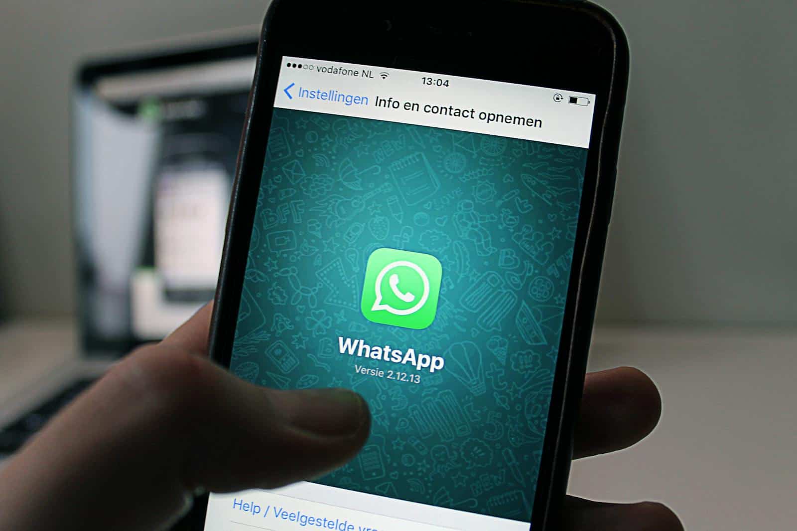 Whatsapp Business, A smartphone displaying the WhatsApp application screen held by a person.
