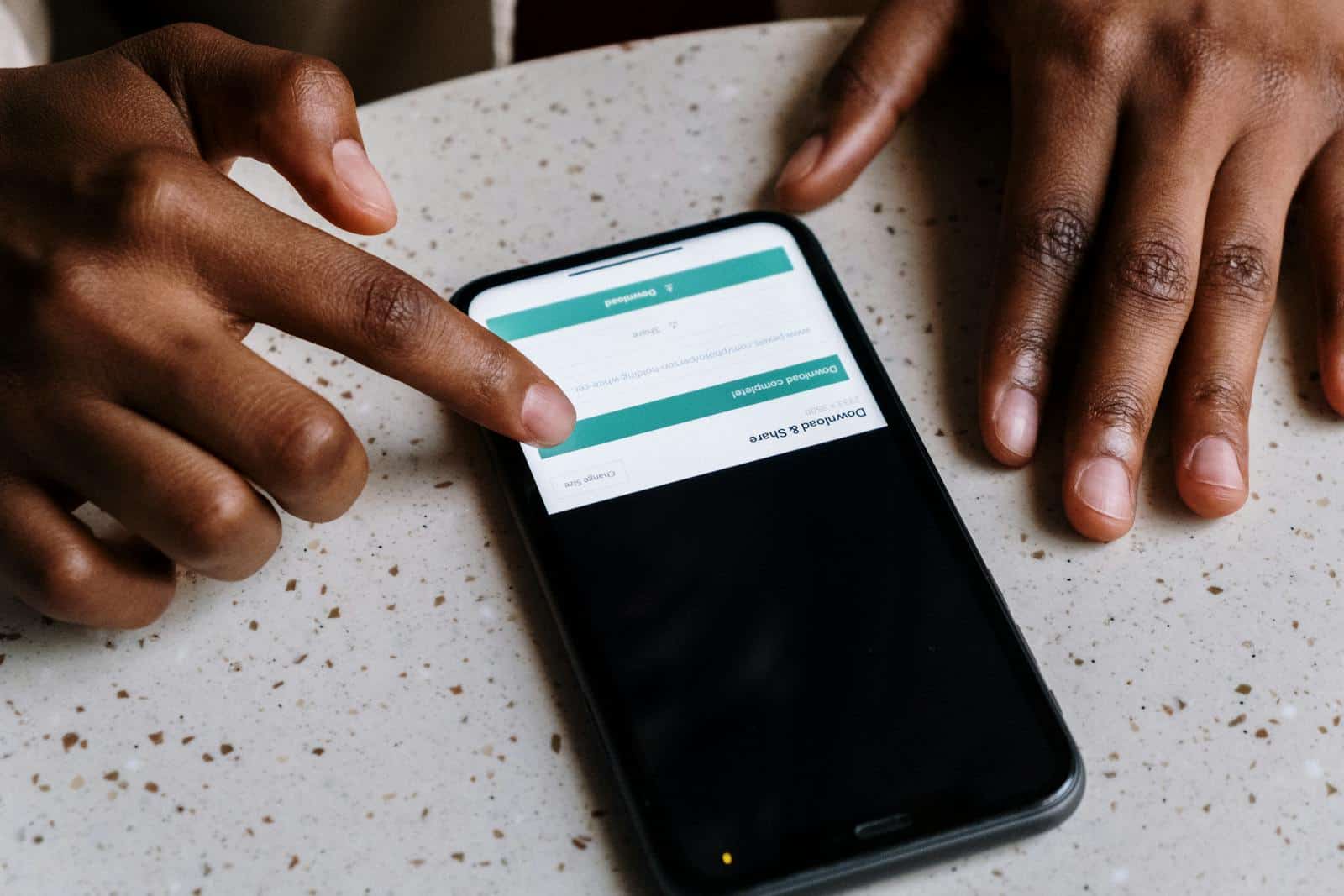 Lead Magnet, b2b marketing, lead generation, sales funnel, digital marketing, case studie, white paper, subscriber list building, Close-up of hands interacting with a smartphone, displaying downloading interface.