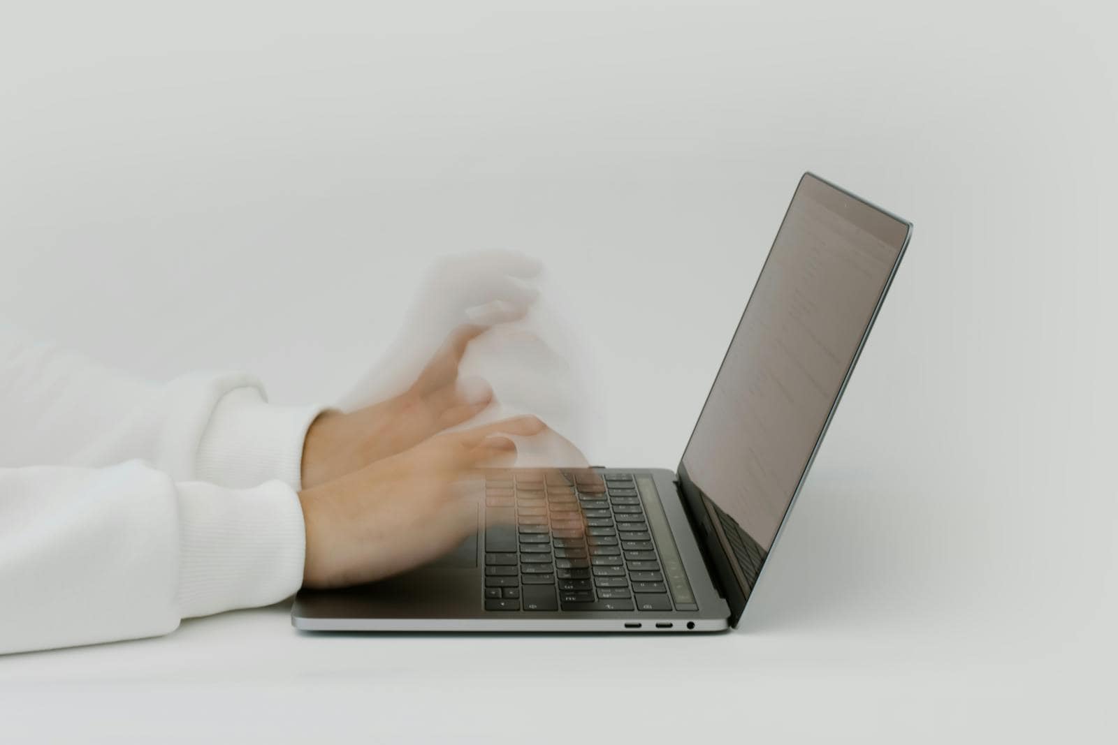 Email, Marketing, Subject line, engagement, Hands rapidly typing on a laptop, illustrating speed and technology in a digital work environment.