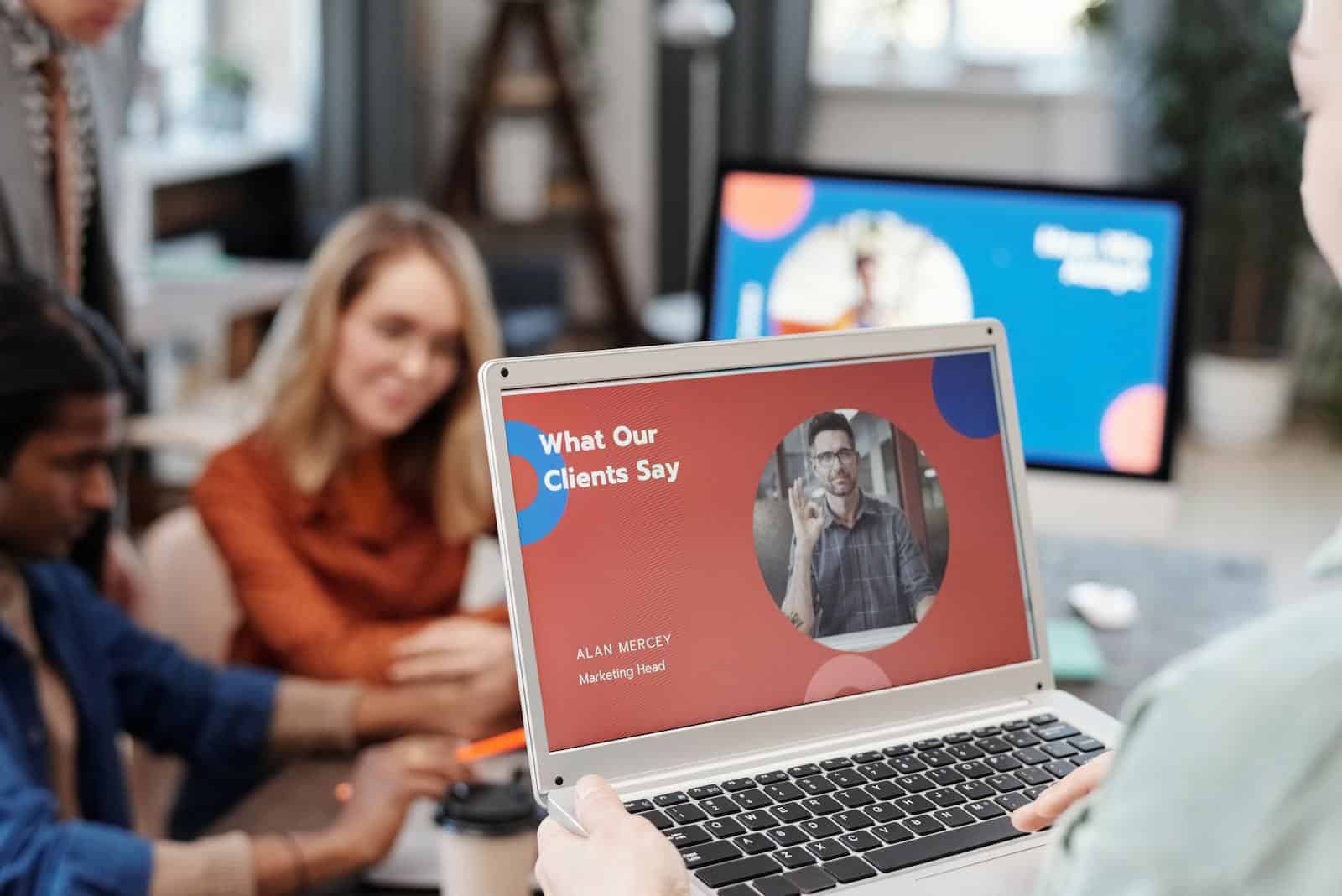 Landing Page Performance: The Key to Converting Visitors, Diverse business team in a meeting analyzing client testimonial on laptop screen.