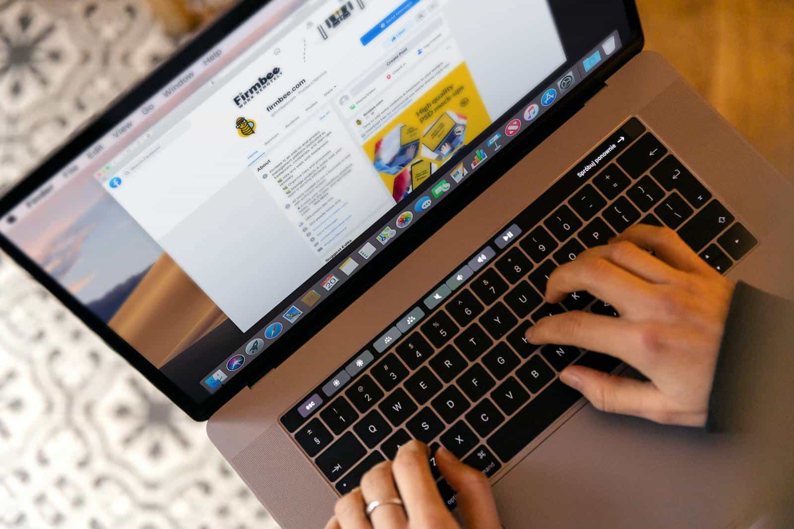 Maximizing Conversions: A Guide to Mastering the Marketing Funnel, Hands typing on a laptop at a desk, engaging in online work, and navigating social media.