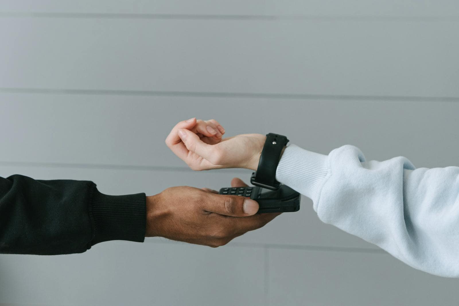 IoT, Internet of Things, 5G technology, A person using a smartwatch for a secure contactless payment on a portable terminal indoors.