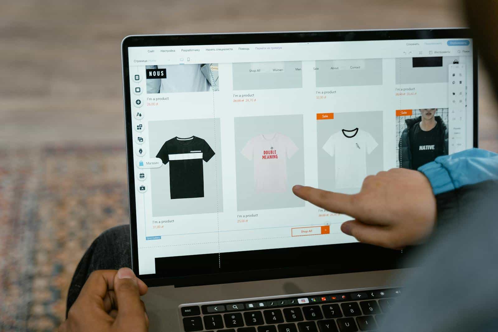 WooCommerce, online store, e-Commerce, Elementor, A person points to t-shirt options in an online store on a laptop screen.