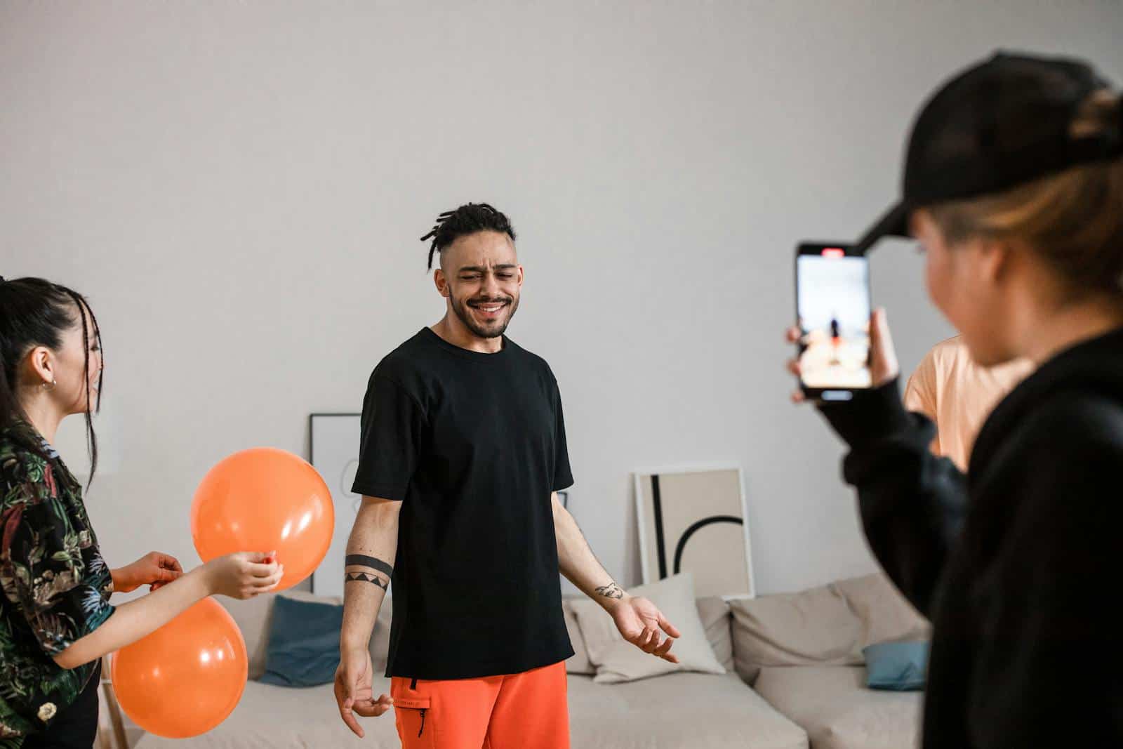 Instagram, Influencer, Social Media Marketing, A group of friends filming a playful TikTok dance video indoors, capturing joy and creativity.