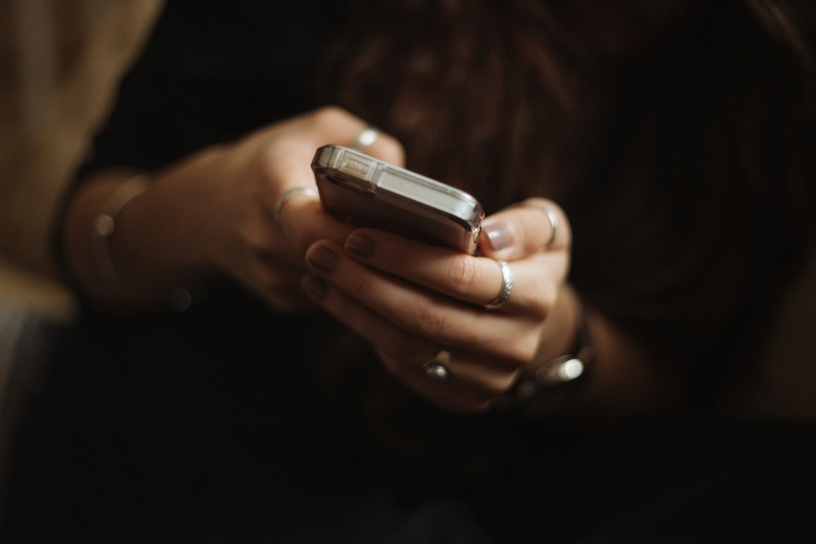 Content Moderation, person using smartphone