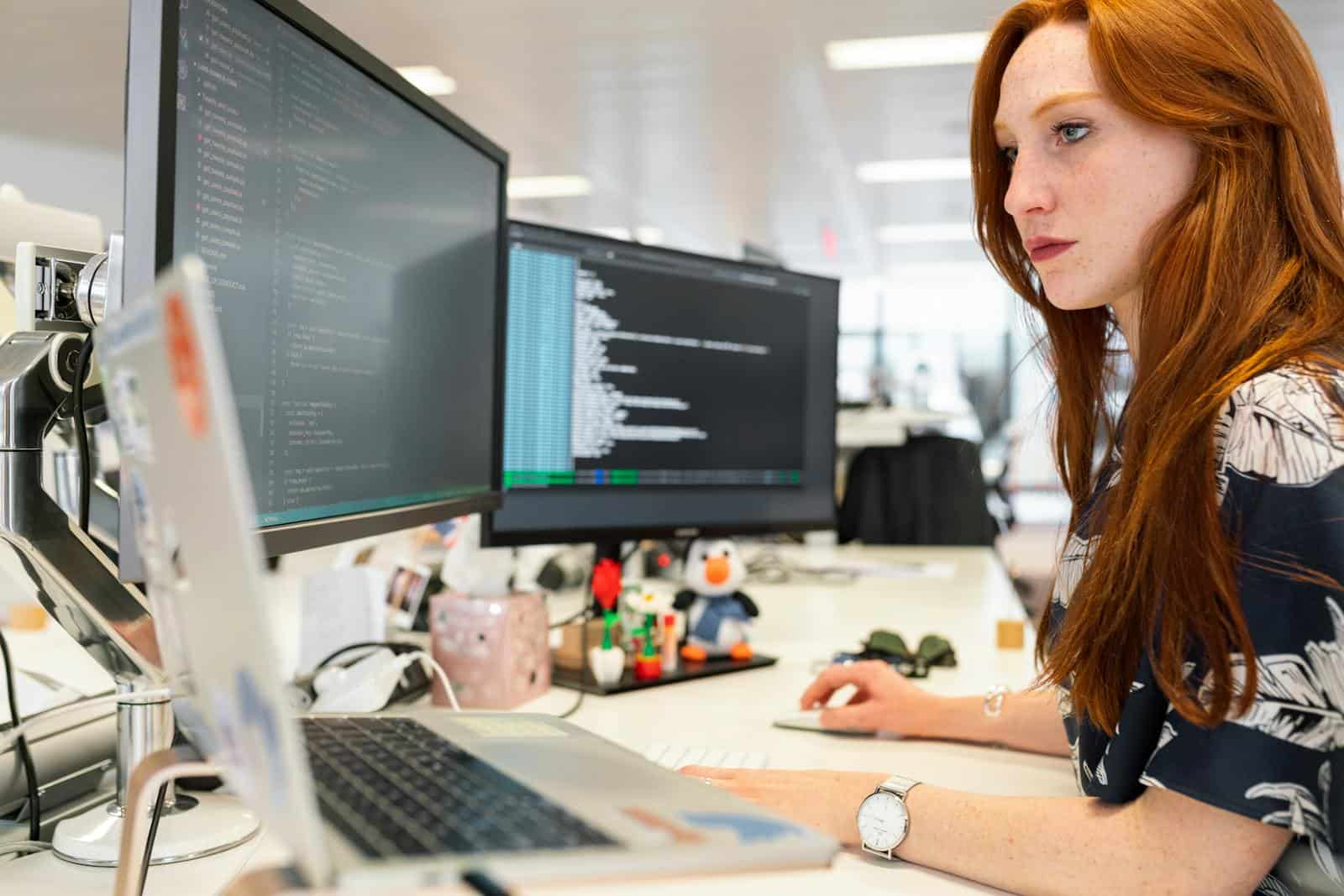 Jet Engine, CrocoBlocks, Plugin, Website, Development, Custom Post Type, Dynamic Content, Ecommerce Website, Blog, Development, Listing, Custom Post Type, Taxonomies, Dynamic, Hosting, A focused female software engineer coding on dual monitors in a modern office.