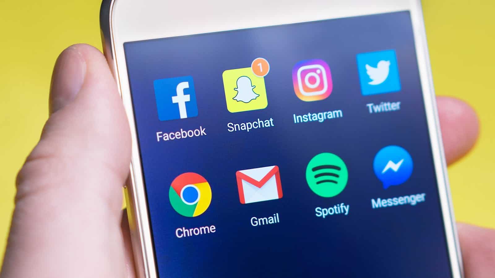 Missing Lettr, Social Media Marketing, Marketing Automation, LinkedIn, X, Twitter, Masterdon, Facebook, Google, Medium, Posts, Engagement, Analytics, Online Advertising, Content Calendar, A person's hand holding a smartphone displaying social media and communication apps.