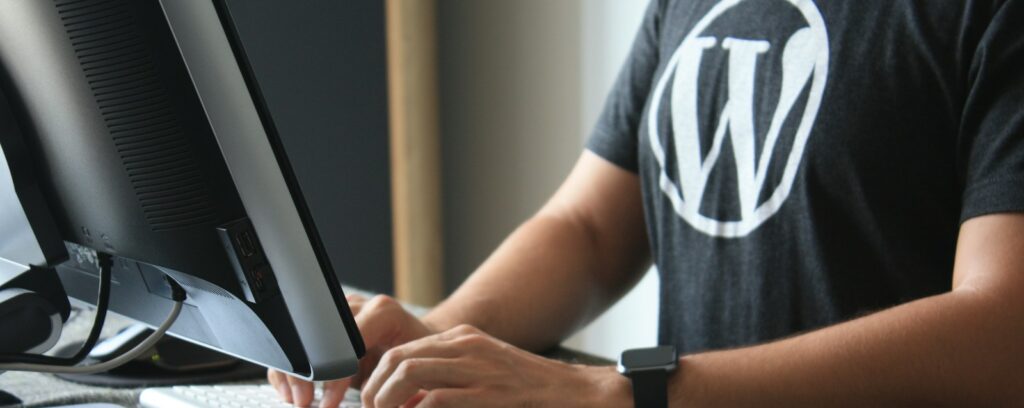 person in black and white t-shirt using computer, WordPress, Gemini 3, Artificial Intelligence