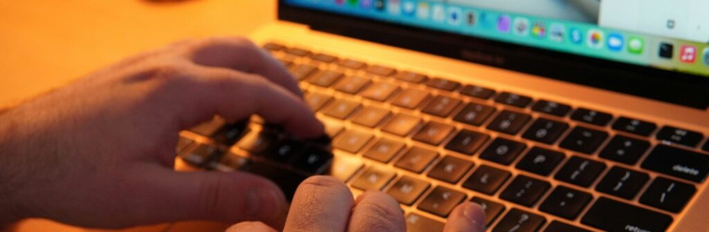 Elementor Atomic Elements, a pair of hands typing on a laptop keyboard